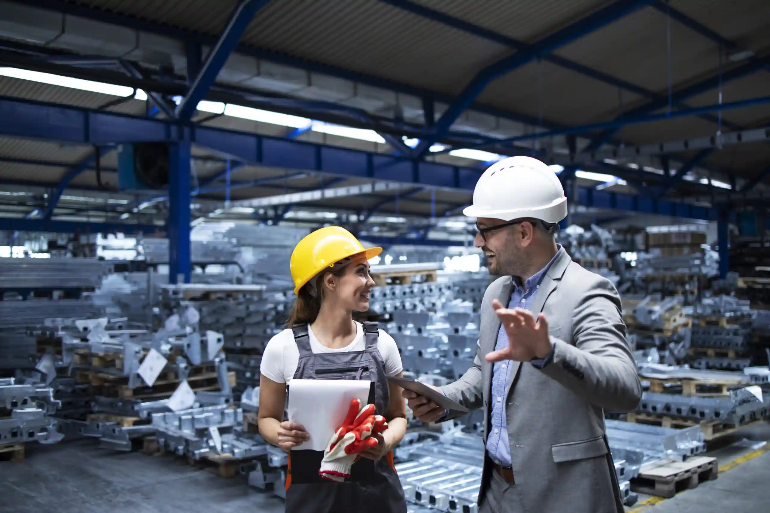 Manager wearing hardhat and industrial worker